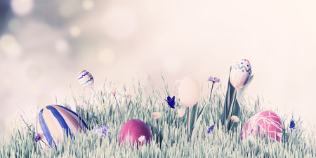 Easter eggs and flowers in green grass, vintage holiday background. Spring sunny day