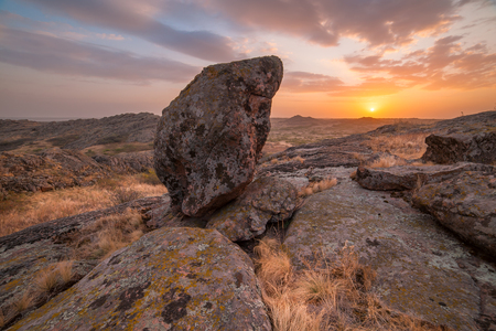 Landscape with majestic sunset in stone valley, beautiful clouds in skyの写真素材