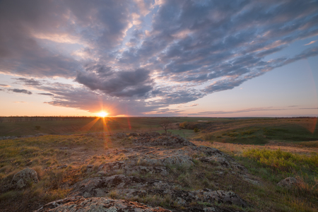 Sunrise over valley with clouds and sun, spring landscapeの写真素材