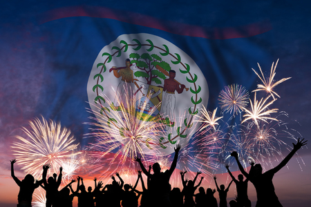 Happy people are looking holiday fireworks with flag of Belize in sky, independence dayの写真素材