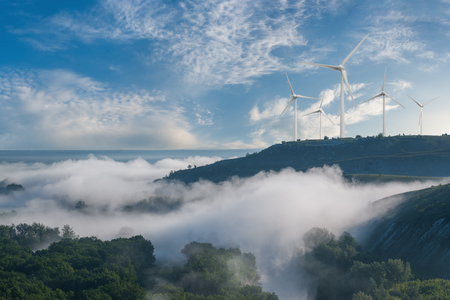 Industrial landscape with wind turbines on hill, renewable eco energy, electric windmills
