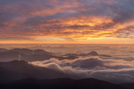 Industrial landscape with wind turbines in mountains, renewable eco energy, electric windmills
