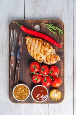 Fried chicken fillet and grilled vegetables, delicious barbecue dinner, flat lay food backgroundの写真素材