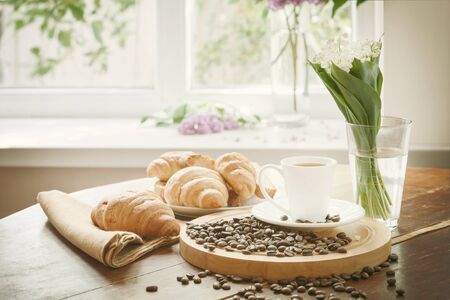 Breakfast with aromatic black coffee, good morning, great start to the day. Coffee break, copy space. Retro stylization, vintage film filterの写真素材