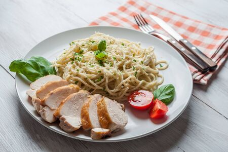 Italian spaghetti pasta with sauce and chicken, cheese parmesan and basil. Food background, selective focusの写真素材