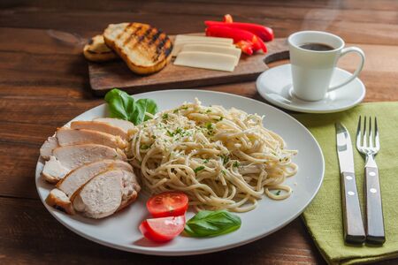Italian spaghetti pasta with sauce and chicken, cheese parmesan and basil. Food background, selective focusの写真素材