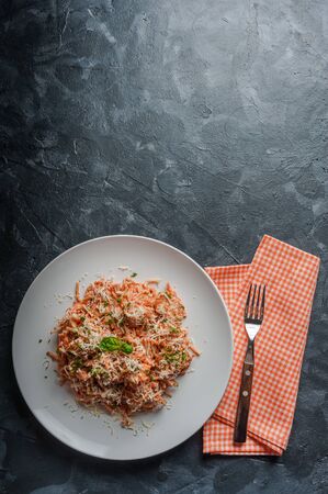 Italian spaghetti pasta with sauce and chicken, cheese parmesan and basil. Food background, flat layの写真素材