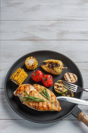 Fried chicken fillet and boiled vegetables, delicious barbecue dinner, flat lay food backgroundの写真素材