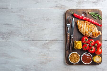 Fried chicken fillet and boiled vegetables, delicious barbecue dinner, flat lay food backgroundの写真素材