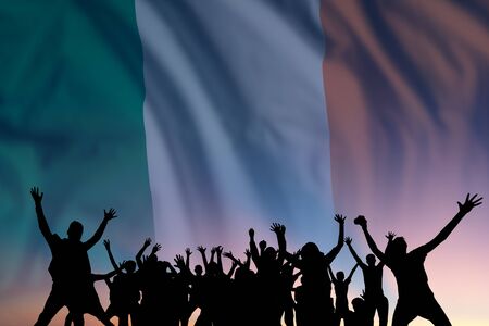Peoples silhouette on flag and sky background, day of Ireland, independence holidayの写真素材