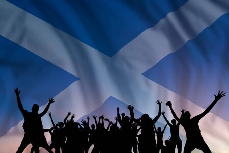 Peoples silhouette on flag and sky background, day of Scotland, independence holiday の写真素材