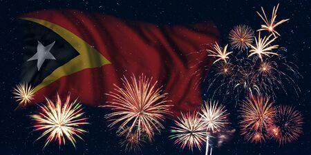 Holiday sky with fireworks and flag of East Timor, independence day of countryの写真素材