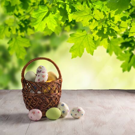 Happy easter painted eggs on wooden colorful table, holiday background for your decoration. Copy spaceの写真素材