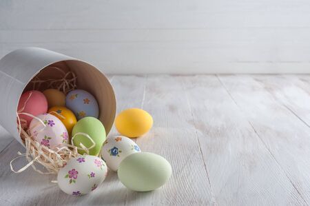 Happy easter painted eggs on wooden colorful table, holiday background for your decoration. Copy spaceの写真素材