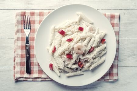 Italian spaghetti pasta with sauce and shrimp, cheese parmesan and basil. Food background, flat lay. Vintage stylization, retro film filterの写真素材