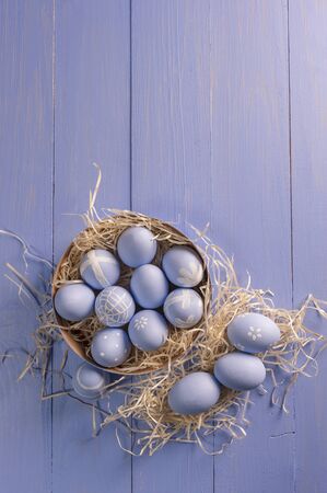 Easter painted eggs on wooden colorful table, holiday background for your decoration. Egg hunt, copy spaceの写真素材