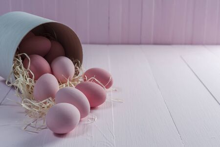 Easter painted eggs on wooden colorful table, holiday background for your decoration. Egg hunt, copy spaceの写真素材