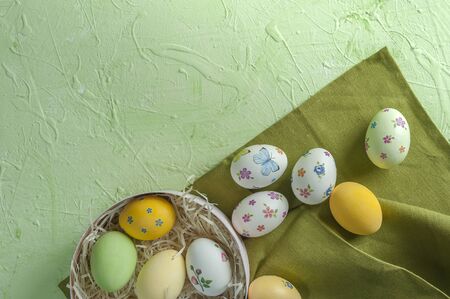 Happy easter painted eggs on wooden colorful table, holiday background for your decoration. Egg hunt, copy spaceの写真素材