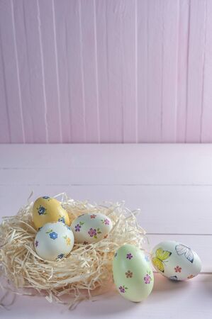 Happy easter painted eggs on wooden colorful table, holiday background for your decoration. Egg hunt, copy spaceの写真素材