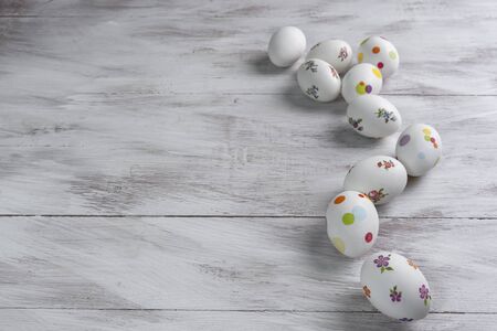 Happy easter painted eggs on wooden colorful table, holiday background for your decoration. Egg hunt, copy spaceの写真素材