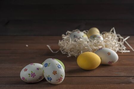 Happy easter painted eggs on wooden colorful table, holiday background for your decoration. Egg...