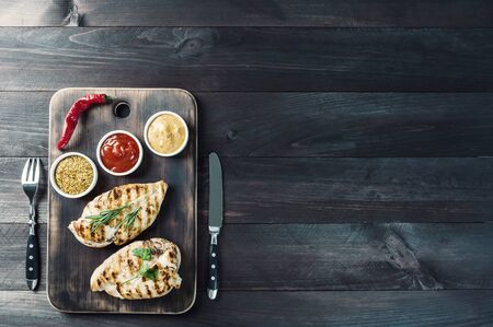 Fried chicken fillet and boiled vegetables, delicious barbecue dinner, flat lay food background. Vintage stylization, retro film filterの写真素材