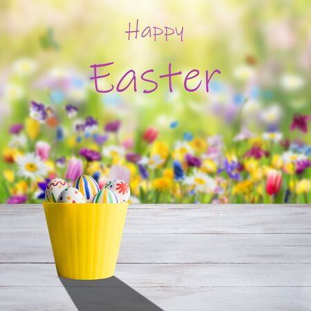 Easter painted eggs on and flowers, holiday background for your decoration. Egg hunt, copy space, "Happy Easter" letteringの写真素材