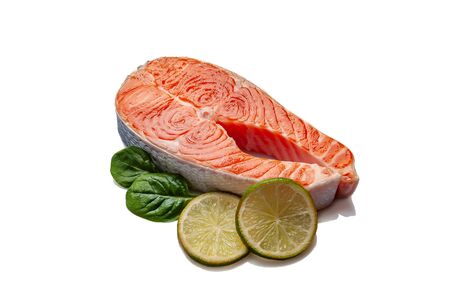 Fresh salmon fishes isolated on white background. Prepared to cooking, vegetables and fresh sea foodの写真素材