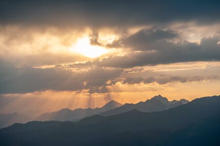 Beautiful landscape with sunset in mountains. Majestic peaks and sky. Enjoy travel adventureの写真素材