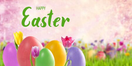 Easter colorful eggs and tulip flowers, holiday background for greetings card. Happy Easter hand letteringの写真素材