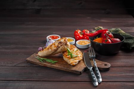 Fried chicken fillet and grilled vegetables, delicious barbecue dinner, food background, selective focusの写真素材