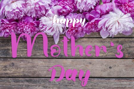 Holiday greetings card with peonies flowers and hand lettering text Happy Mothers Dayの写真素材