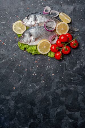 Fresh raw dorado fishes prepared to cooking, vegetables and fresh sea food. Cooking background, flat layの写真素材