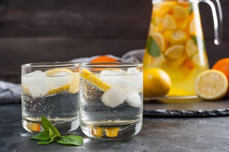 Homemade lemonade with mint from lemone and orange, citrus refreshig beverage in glass. Selective focusの写真素材
