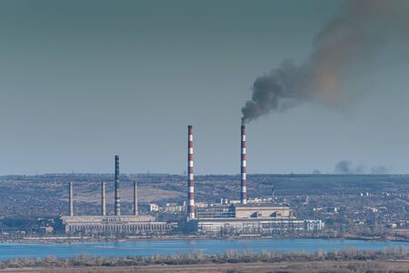 Industrial landscape with smoke from pipes in old factory, ecology catastrophe and climate changeの写真素材