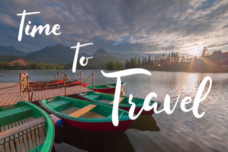 Evening landscape with boats on water and mountains and hand lettering text time to travelの写真素材