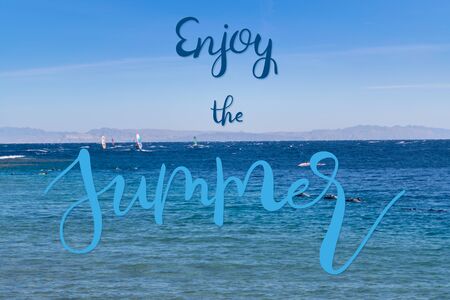 Summer landscape with blue sea and cloud in sky and hand lettering text Enjoy the Summer, vacation backgroundの写真素材
