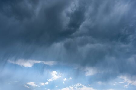 Nature landscape with rain during a thunderstorm and majestic clouds in skyの写真素材