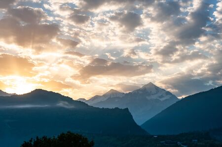 Beautiful landscape with sunny morning in mountains. Majestic peaks and sky. Enjoy travel adventureの写真素材