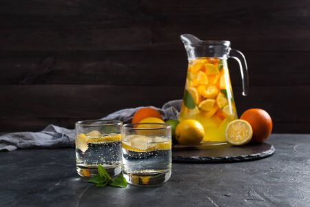 Homemade lemonade with mint from lemone and orange, citrus refreshig beverage in glass. Selective focusの写真素材