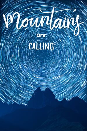 Night landscape with majestic mountain and stars in sky and hand lettering text Mountains are calling, long exposure. Space and Polar star over peaks. Mountaineering and climb backgroundの写真素材