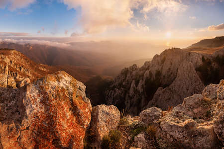 Beautiful sunrise on autumn landscape with mountains and majestic skyの写真素材