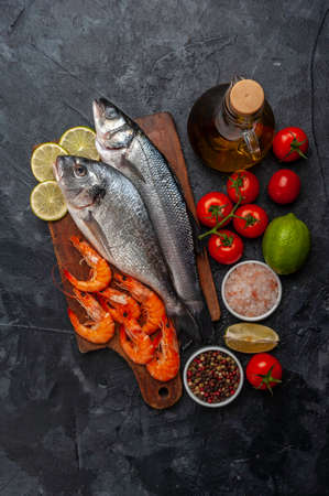 Fresh dorado and seabass fishes on board prepared to cookingの写真素材