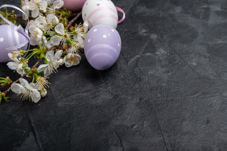 Happy easter card with painted eggs and flowers on colorful table, holiday background for your card. Egg hunt, copy spaceの写真素材