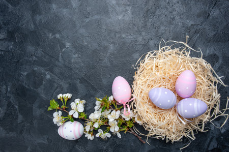Happy easter card with painted eggs and flowers on colorful table, holiday background for your card. Egg hunt, copy spaceの写真素材