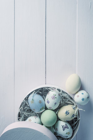 Easter painted eggs on wooden rustic table, holiday background for your decoration. Retro film filter, vintage stylizationの写真素材