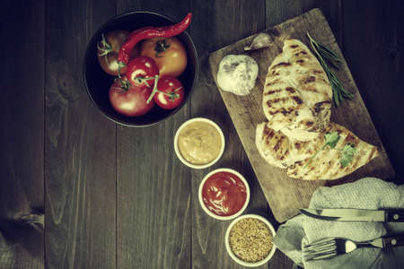 Fried chicken fillet and boiled vegetables, delicious barbecue dinner, flat lay food background....