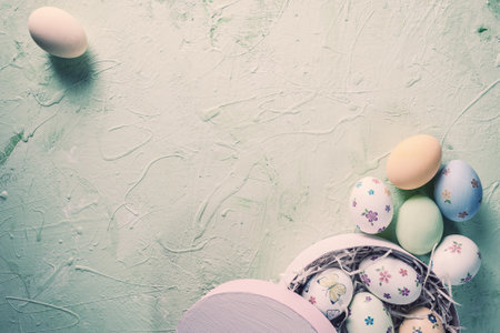 Happy easter painted eggs on wooden colorful table, holiday background for your decoration. Egg hunt, copy space. Retro film filter, vintage stylizationの写真素材