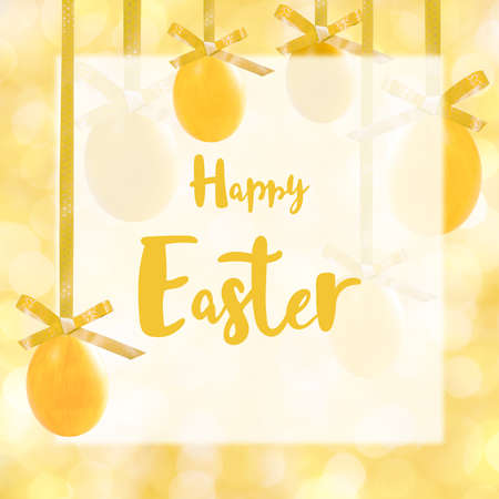 Holiday card with yellow easter eggs hang on ribbon and hand lettering textの写真素材