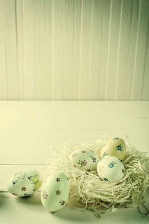 Happy easter eggs on wooden vintage table, holiday background with place for your text. Egg hunt, copy spaceの写真素材
